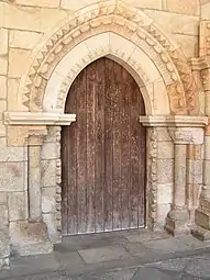 Cloister's entrance door, with a proto-Gothic pointed arch but still from the Romanesque period.