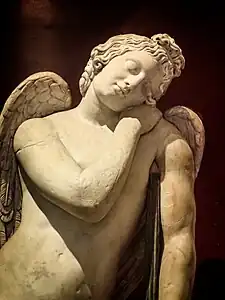 Closeup of Roman statue of Eros, 100-200 CE depicting Eros sleeping,  his torch turned down, a symbol of death used in many Roman memorials.