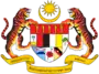 Shield showing the symbols of the Malaysian states with a star and crescent above and a motto below, supported by two tigers