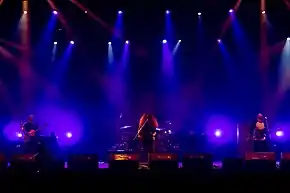 Coheed and Cambria performing in 2016 Left to Right: Travis Stever, Claudio Sanchez, Josh Eppard (obscured, on drums), Zach Cooper