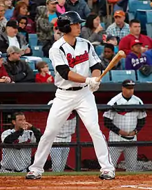 A baseball player in white