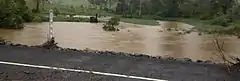 In February, when the flooding resumed, the water level of Coles Creek nearly reached the water level of Maguires Lane, Cooran.