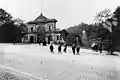 Young boys stand outside the arches on a cobbled Preston New Road