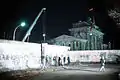 A crane removes a section of the Wall near Brandenburg Gate on 21 December 1989.