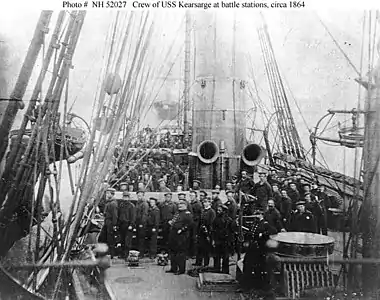 Crew of the USS Kearsarge in 1864 after the battle; showing both 11 Inch guns pointed to starboard as they were during the battle.