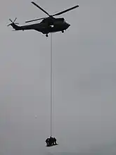 GIGN helicopter carrying a team of operators on ESCAPE, a GIGN-designed device used to carry a team on a platform