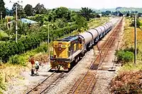 DC 4398 shunting milk wagons at Oringi.