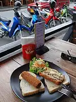 Two Dutch kroketten, one cut open to show the beef-ragout filling; Chiang Mai, Thailand