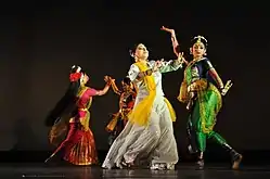 Four women wearing saree in different dancing poses