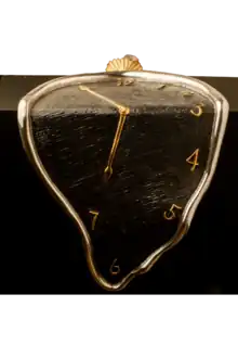 A silver melting clock with black background and golden clock hands.