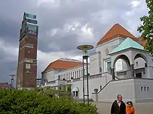 A tower in red brick and an exhibition building