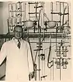 De Maeyer in front of the distillation apparatus, 1955