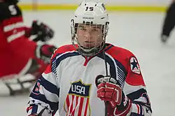 Declan Farmer, wearing a black hockey helmet and red sporting overalls