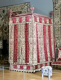 Four-poster bed from the Château d'Effiat; c.1650; natural walnut, chiselled Genoa silk velvet and embroidered silks; 295 cm; Louvre