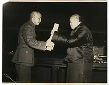 Wu Zhihui, chairman of the National Constituent Assembly, handed the ratified constitution to Chiang Kai-shek, chairman of the Nationalist Government.