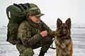 Russian sapper with his German Shepherd mine detection dog in Syria