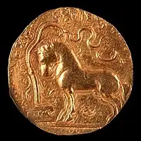 Samudragupta coin with horse standing in front of a yūpa sacrificial post, with legend "The King of Kings, who had performed the Ashvamedha sacrifice, wins heaven after conquering the earth".