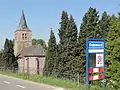 Place name sign of Dodewaard in front of the church of Hien