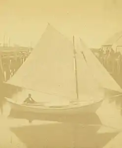 The sailing dory Centennial with Johnson at helm in Gloucester harbor