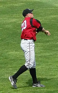 A baseball player in red and gray