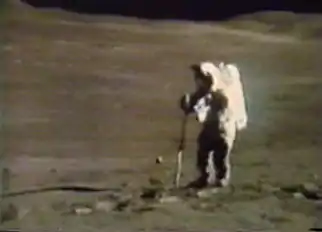 Astronaut Charles Duke extracting a double core at Station 4 on the west slope of Stone Mountain