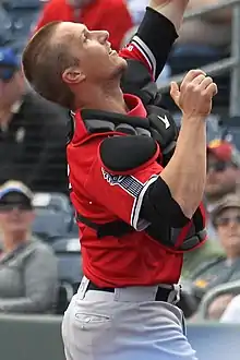 A baseball player in red and gray