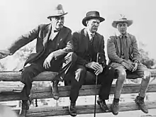 Edward, Prince of Wales, sitting on a corral fence with Archibald J. McLean and George Lane at the EP Ranch in October 1924.