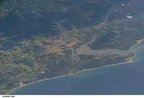 ISS image from 2005 showing the city of Joinville (center) with the Baía da Babitonga, Araquari (center below), to the right São Francisco do Sul with the coast of the South Atlantic.