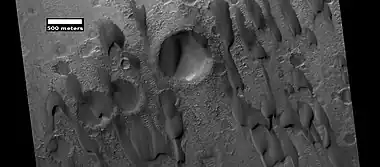 Dunes among craters, as seen by HiRISE under HiWish program.  Some of these are barchans.