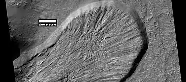 Landslide in a crater, as seen by HiRISE under HiWish program Image from Iapygia quadrangle.