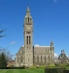 A Gothic Revival chapel with a tall Big Ben-like clock tower