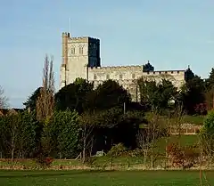 An impressive stone church on a hill with a battlemented tower and nave