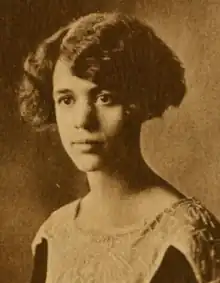 A young woman with dark wavy hair cut in a side-parted bob