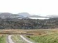 End of the Badcall road. The end of the single track road to Badcall. From here on it is a grass strip down the middle of road to the last crofts around the corner.