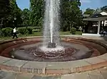 Geyser, located in the middle of a stonework, erupting