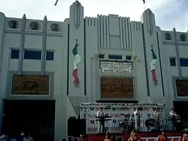 photo of main entrance with band and cheerleaders