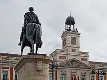 Monument to King Charles III in front of the House of the Post Office