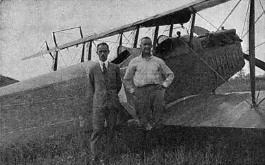 E. Dormoy (left) and pilot Lieut. J. A. Macready (right) in front of the 1st crop duster airplane (August 3, 1921)