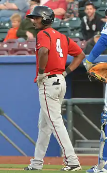 A baseball player in red and gray