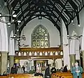 The west wall, showing the balcony and the Stations of the Cross and Resurrection by parishioner Iain McKillop