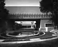 View over the round pool, with the central courtyard and living room beyond (1921)