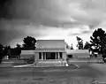 Hollyhock House with broad flat lawn, ornamental square pool, showing parts of the wings layout, 1921