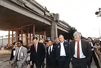 Rep. Pete Stark, Mayor Lionel J. Wilson, President George H. W. Bush, and Rep. George Miller inspect Cypress Street Viaduct damage.