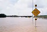 A "Watch for Water on Road" sign in the United States.