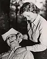 Clean Shaven, A student smiles as his beard removal is almost complete