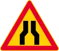 Road narrows on both sides