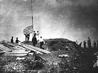 First Marine Battalion (United States) hoisting the flag at the Battle of Guantánamo Bay during the Spanish–American War, in 1898.