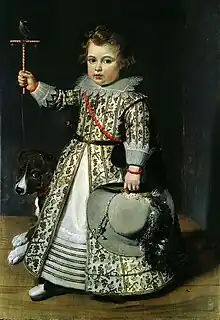 Young Boy of 1625 wearing a  gown and kirtle shortened by deep tucks near the hem.