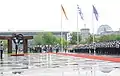 Order of precedence at the state visit of Greek prime minister Antonis Samaras in Berlin (24 August 2012): The Greek flag takes the first order of precedence, followed by the German flag on the right (seen on the left when facing the building) and the European flag in third order, on the left.