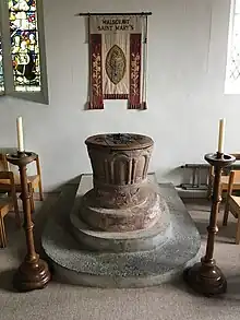 Red sandstone font from the Norman chapel that stood on the site of St Mary's before 1300.